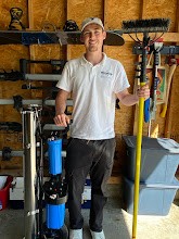 AllPro Exteriors technician with professional cleaning equipment